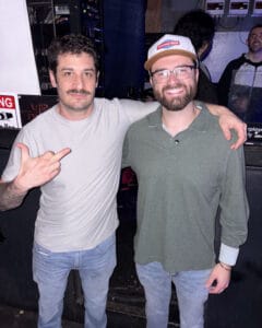 Jacob Guidry backstage with fellow performer at comedy club venue
