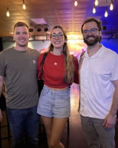 Jacob Guidry posing with audience members after a live stand-up comedy event