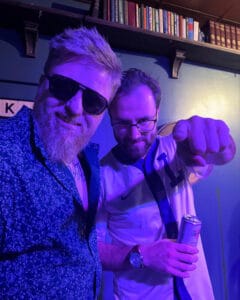 Jacob Guidry posing backstage with fellow comedian before a live stand-up comedy performance