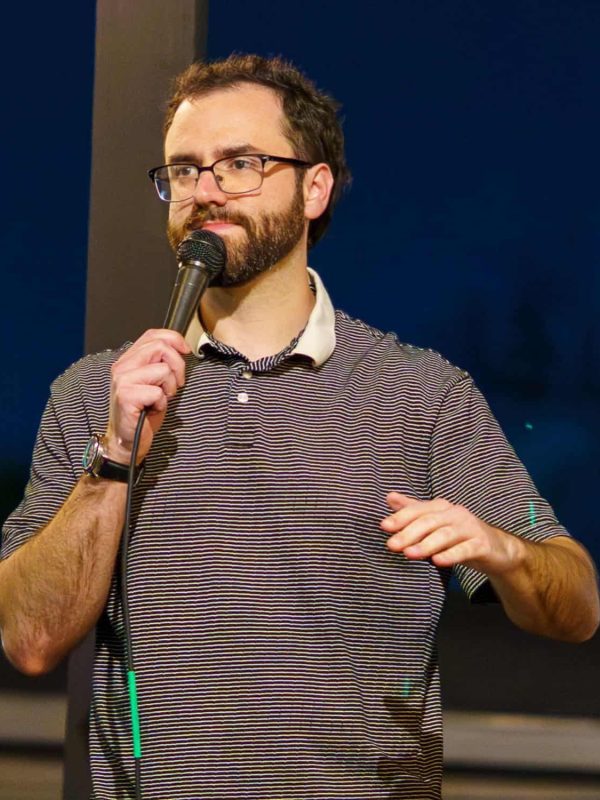 Jacob Guidry speaking during a stand-up comedy performance