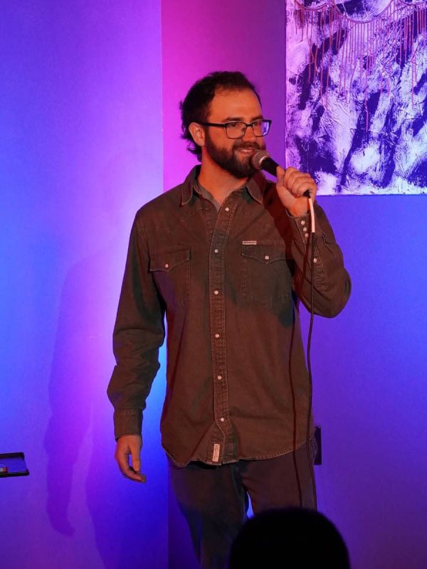 Jacob Guidry performing stand-up comedy on stage in Louisiana